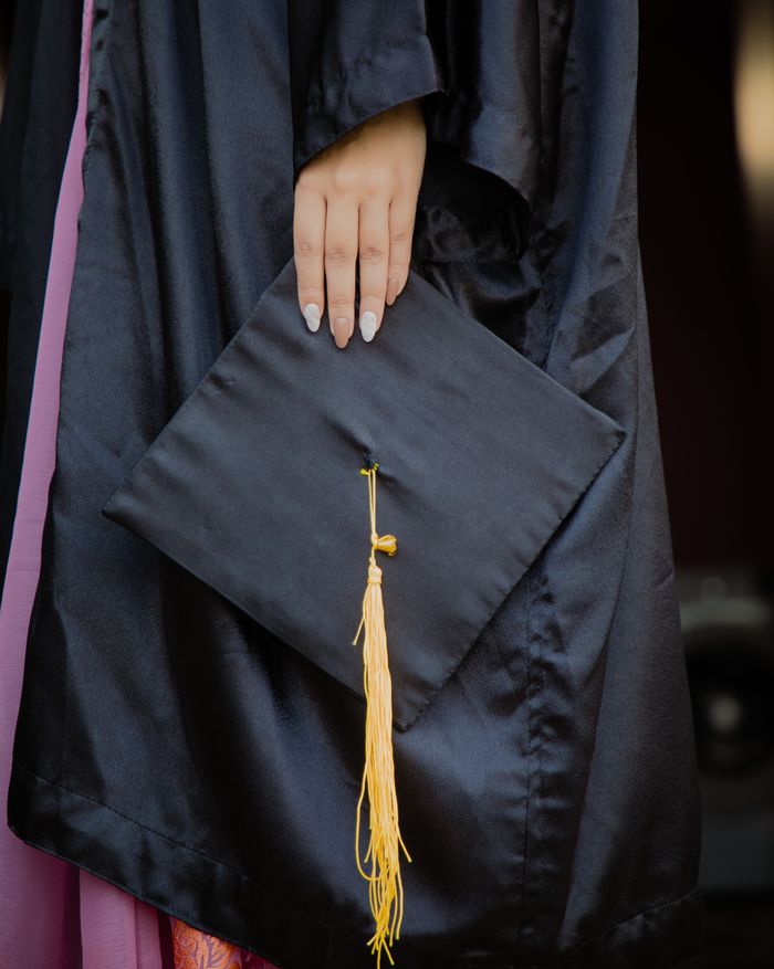about-06 Close-up of a graduation cap and gown, symbolizing academic achievement.