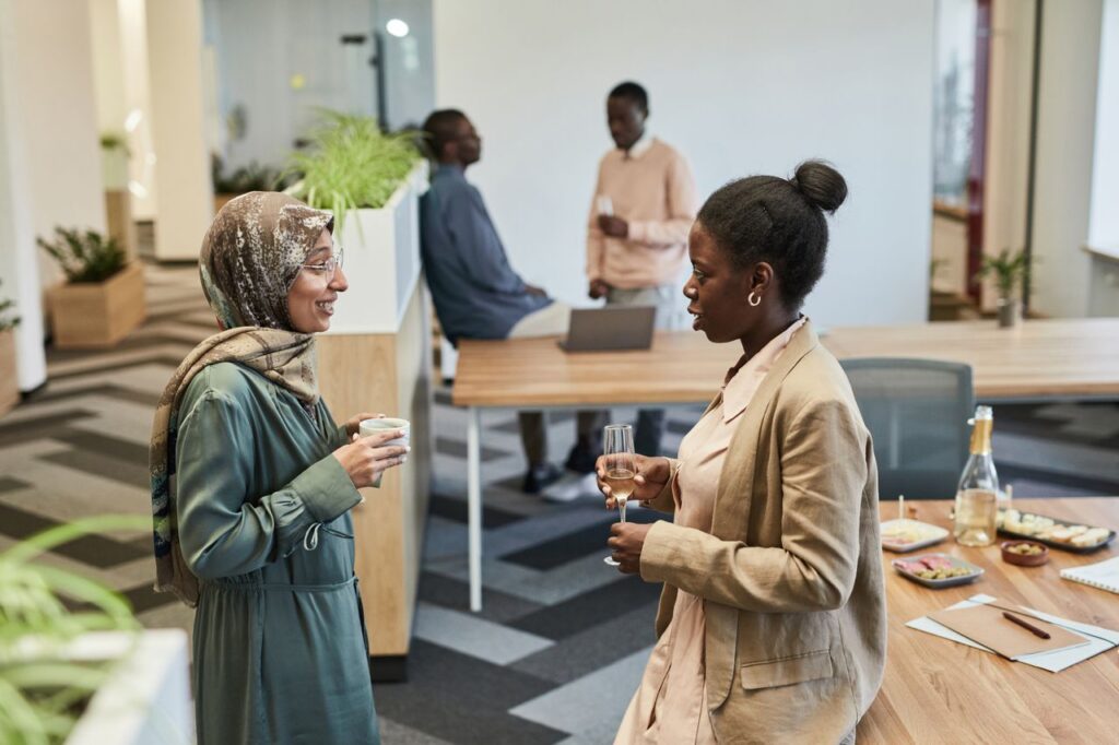 Group of diverse professionals networking in a modern office setting.